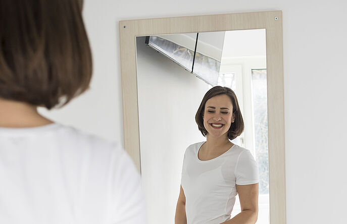 Fitting Expertise Shopper trying on clothes in front of a mirror