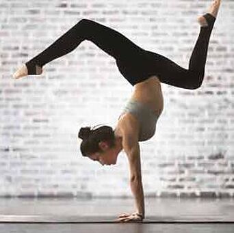 Yogi posed in handstand on yoga mat